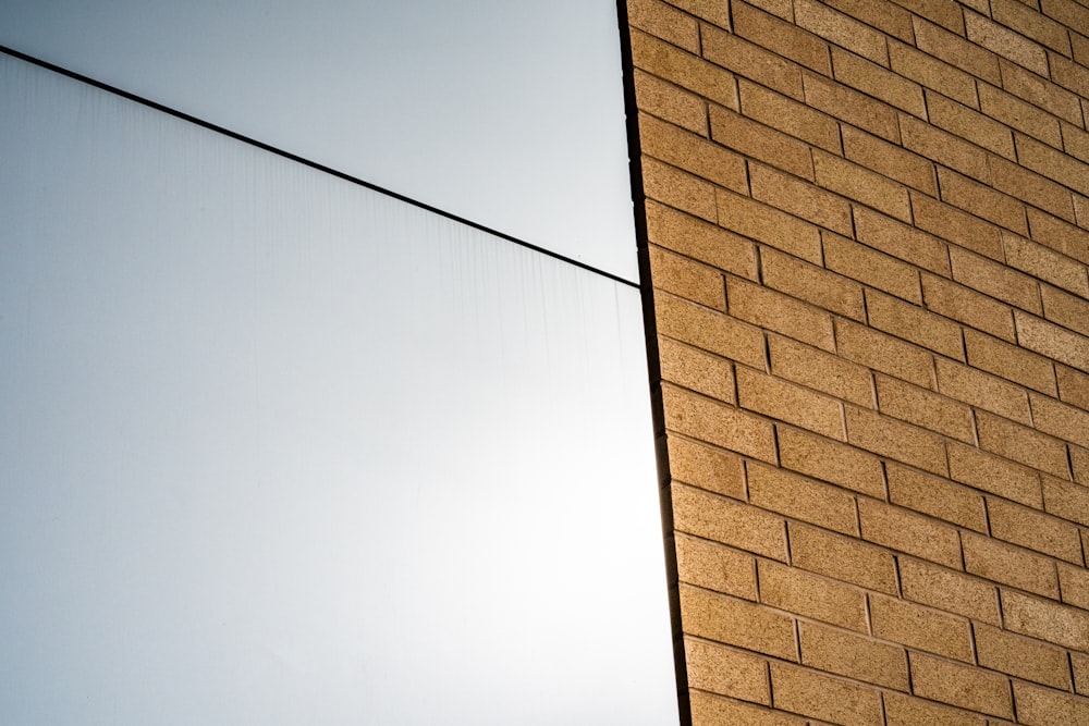 brown brick wall under white sky during daytime