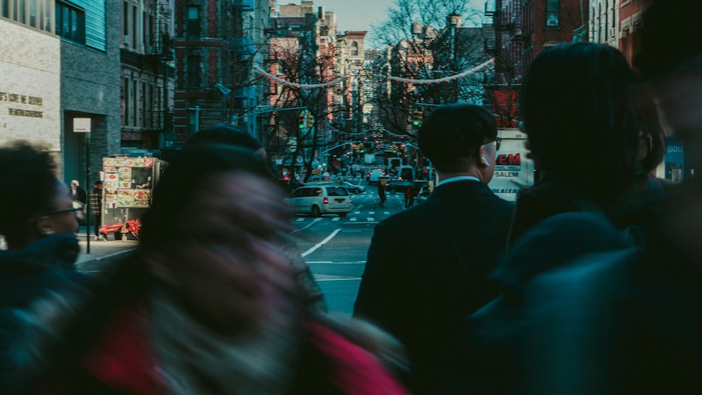 man in black suit standing near road during night time