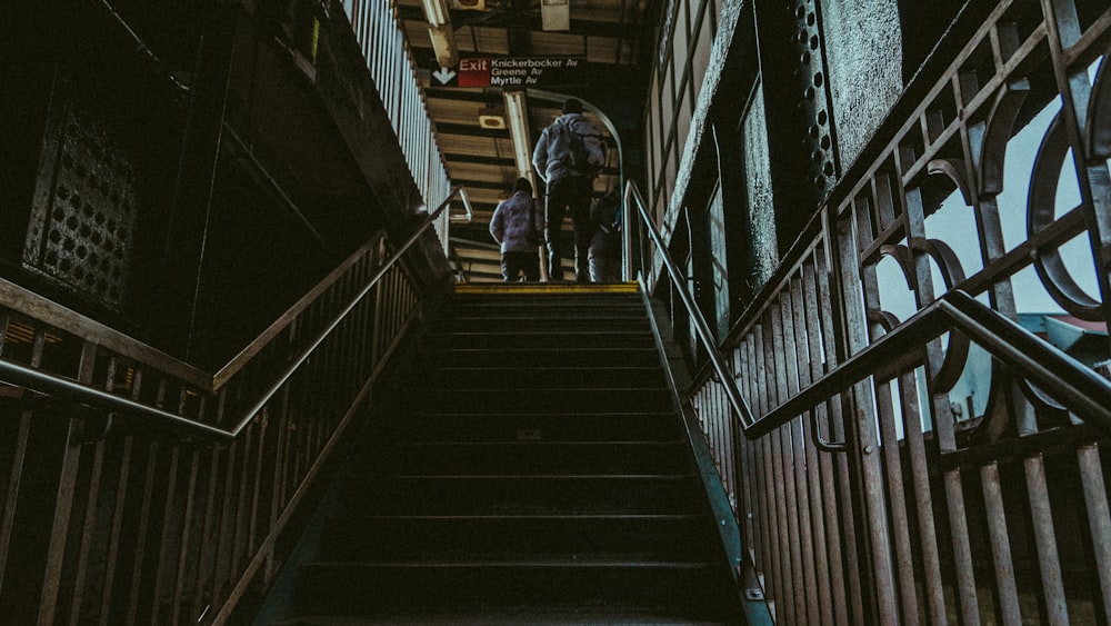 man in black jacket walking down the stairs