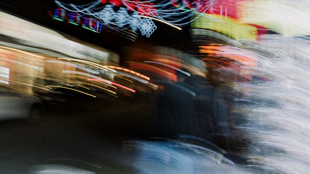 A surreal collage of blurred faces and flickering neon lights capturing a mysterious, vintage atmosphere.