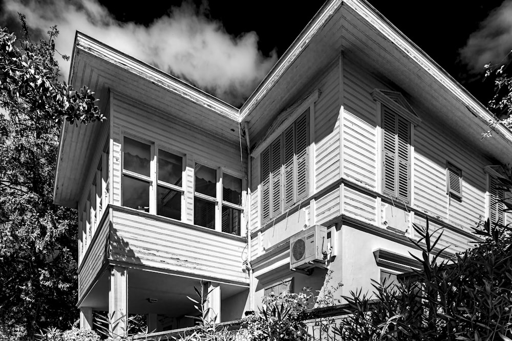 grayscale photo of 2 storey house