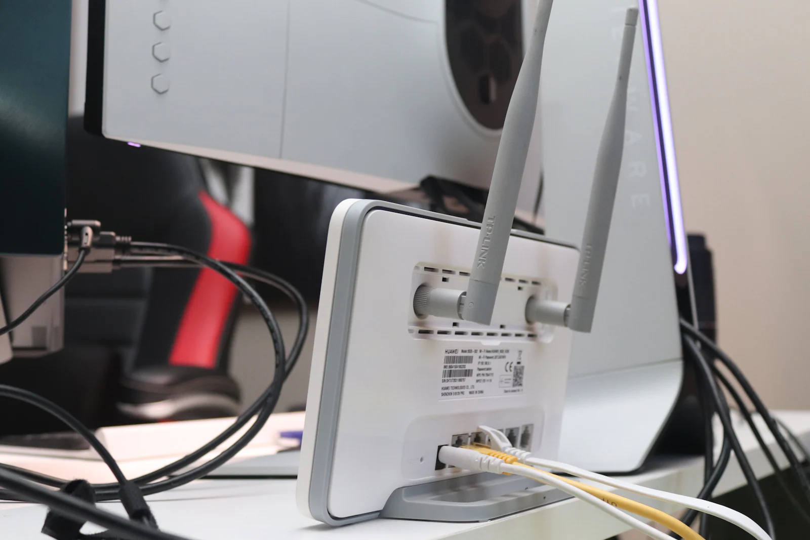 A small-shop office corner with a desktop computer and network router