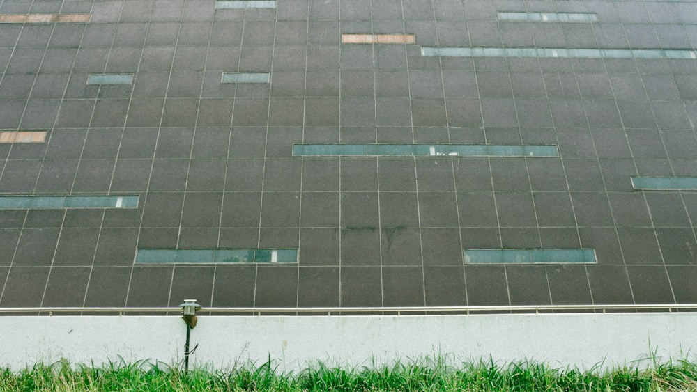 green grass field near gray concrete road