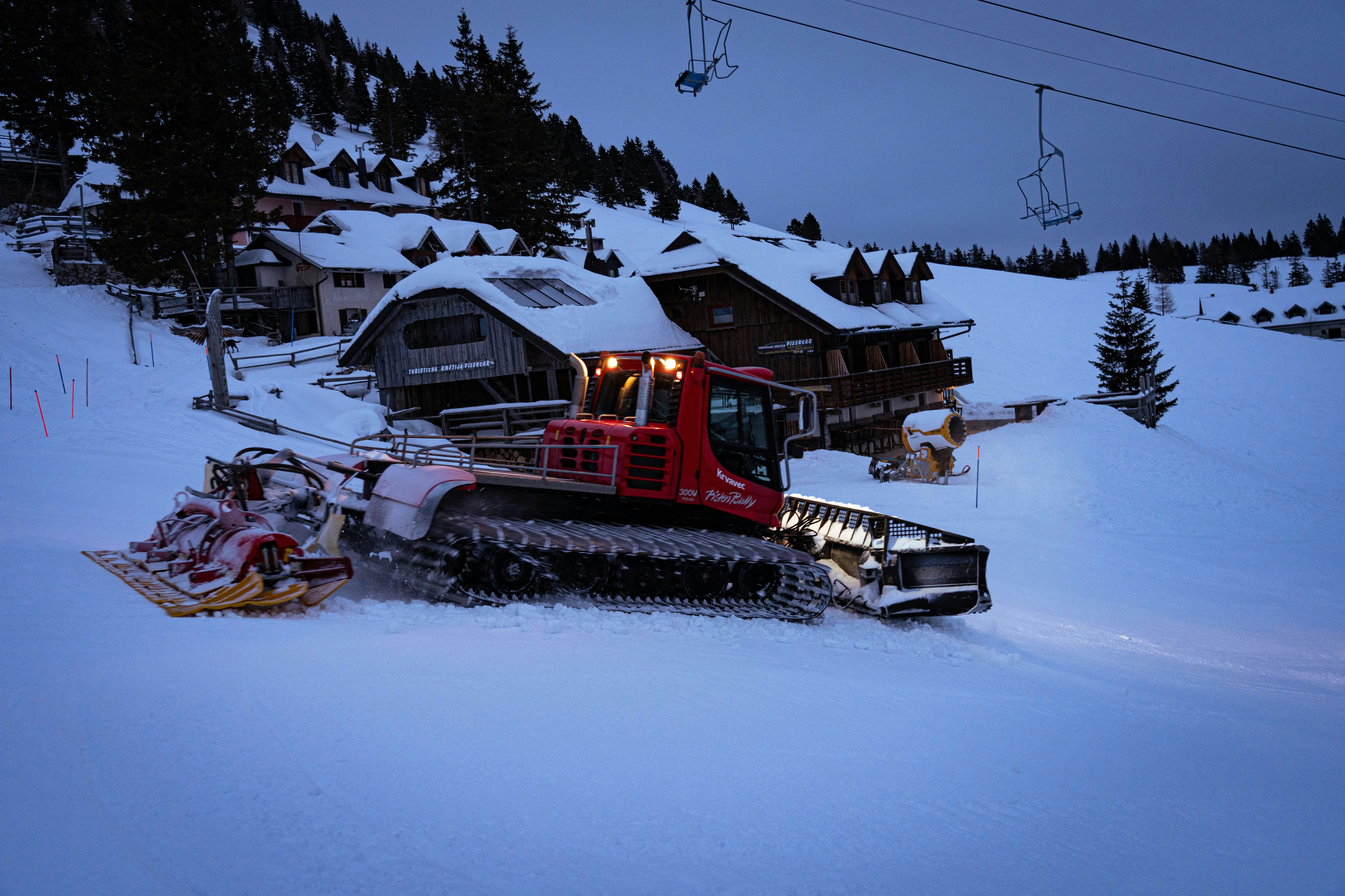 red and black train on snow covered ground during daytime wintry teams background