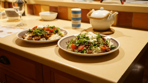 A warm beige kitchen counter with a bowl of healthy rice and assorted spices arranged neatly.