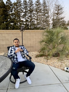 Casual men's outfit featuring a soft cotton t-shirt and relaxed-fit jeans on a rustic chair.