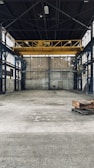 Industrial warehouse transformation with polished concrete floors and high ceilings.