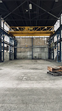 Renovated industrial warehouse with fresh concrete and steel beams.