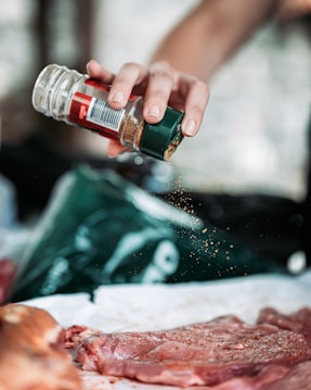 person holding green and red bottle