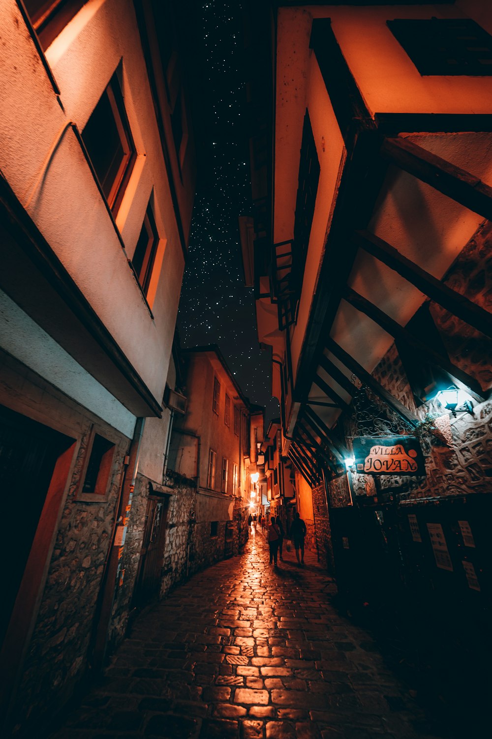 brown brick building with string lights during night time