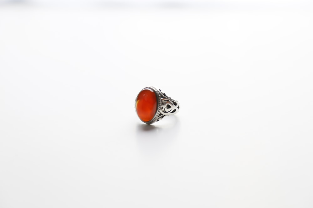 silver and orange stone ring