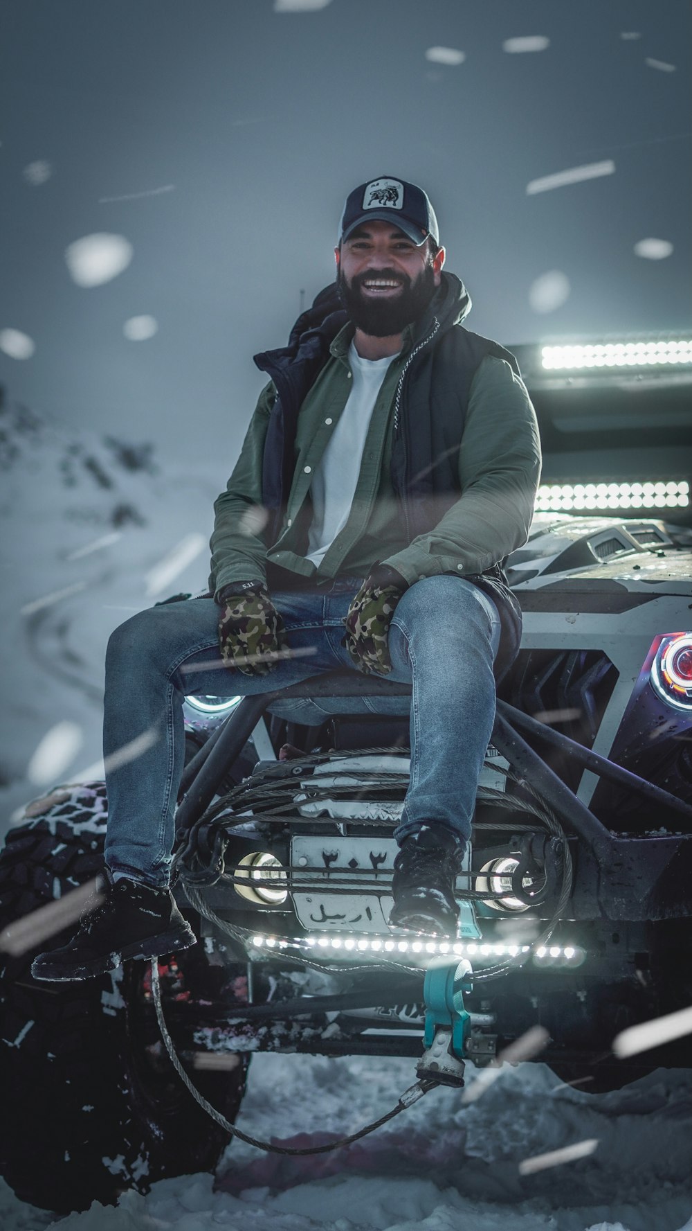 a man sitting on top of a motorcycle in the snow