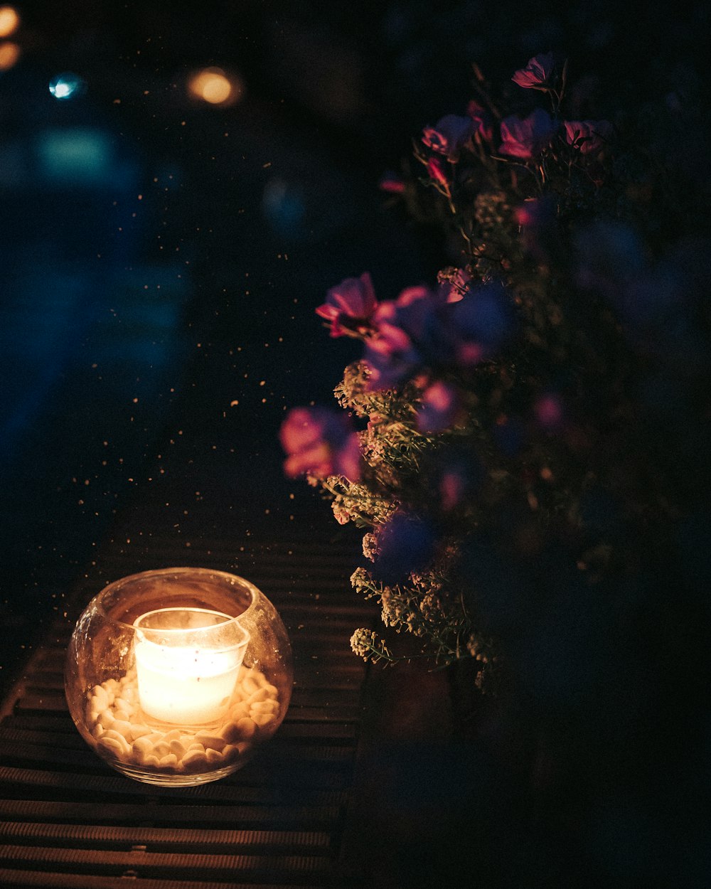 lighted candle in clear glass holder