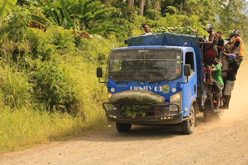 A Velocicarga truck crossing a border checkpoint with customs officials.