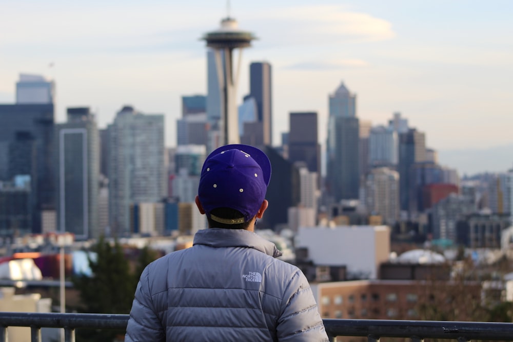 a person wearing a blue helmet looking at a city