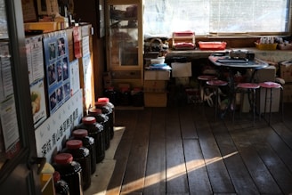 A cozy wooden counter with jars of dried herbs and a softly glowing yellow moon logo hanging above.