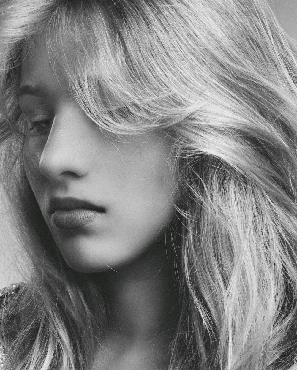woman with blonde hair in grayscale photography