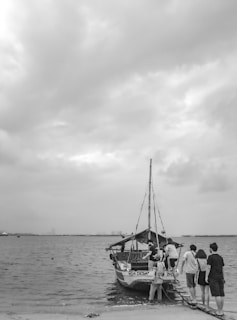 A small group boarding a comfortable tour boat at the Antsiranana port.
