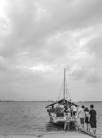 A small group boarding a comfortable tour boat at the Antsiranana port.
