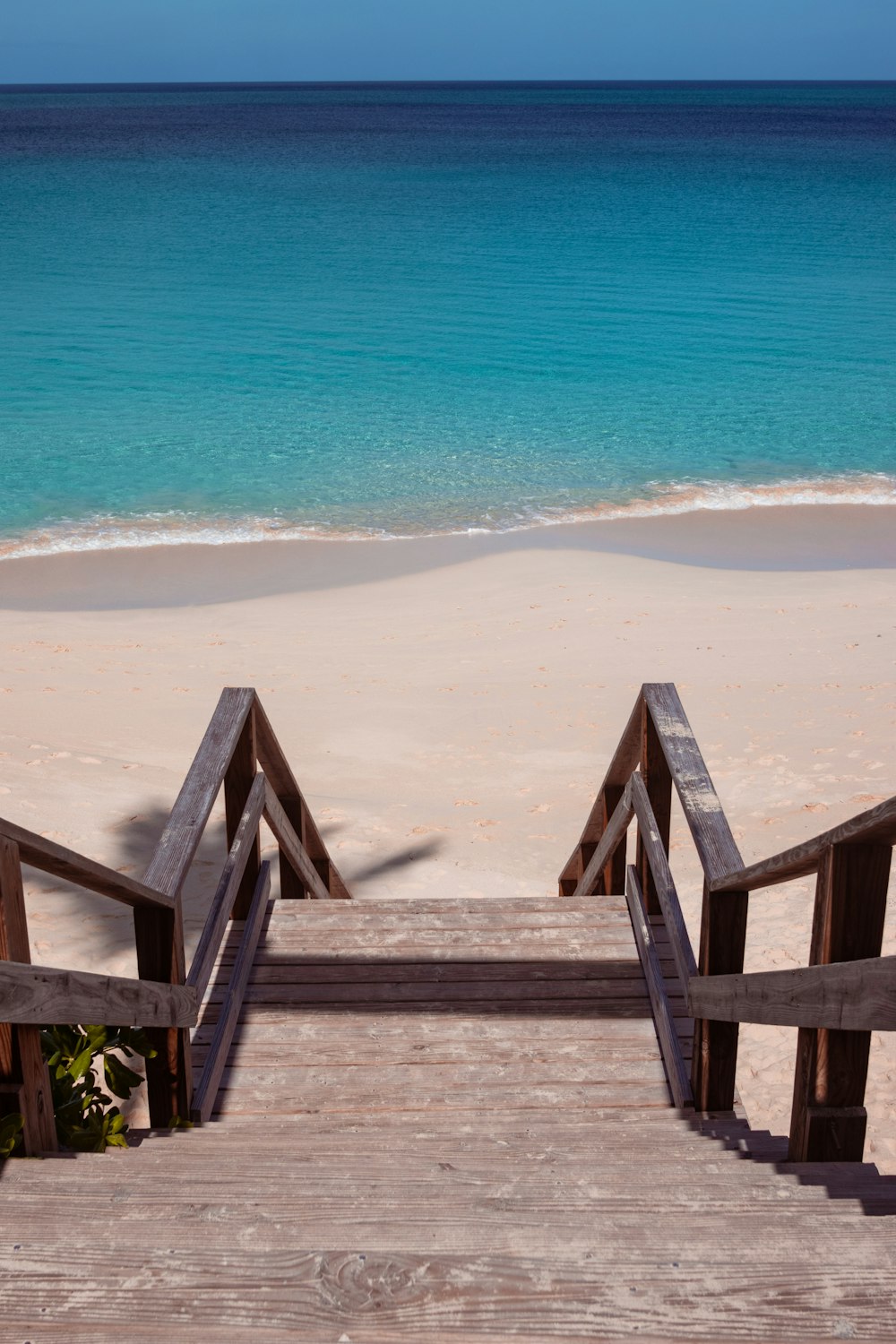 brown wooden bridge on beach during daytime