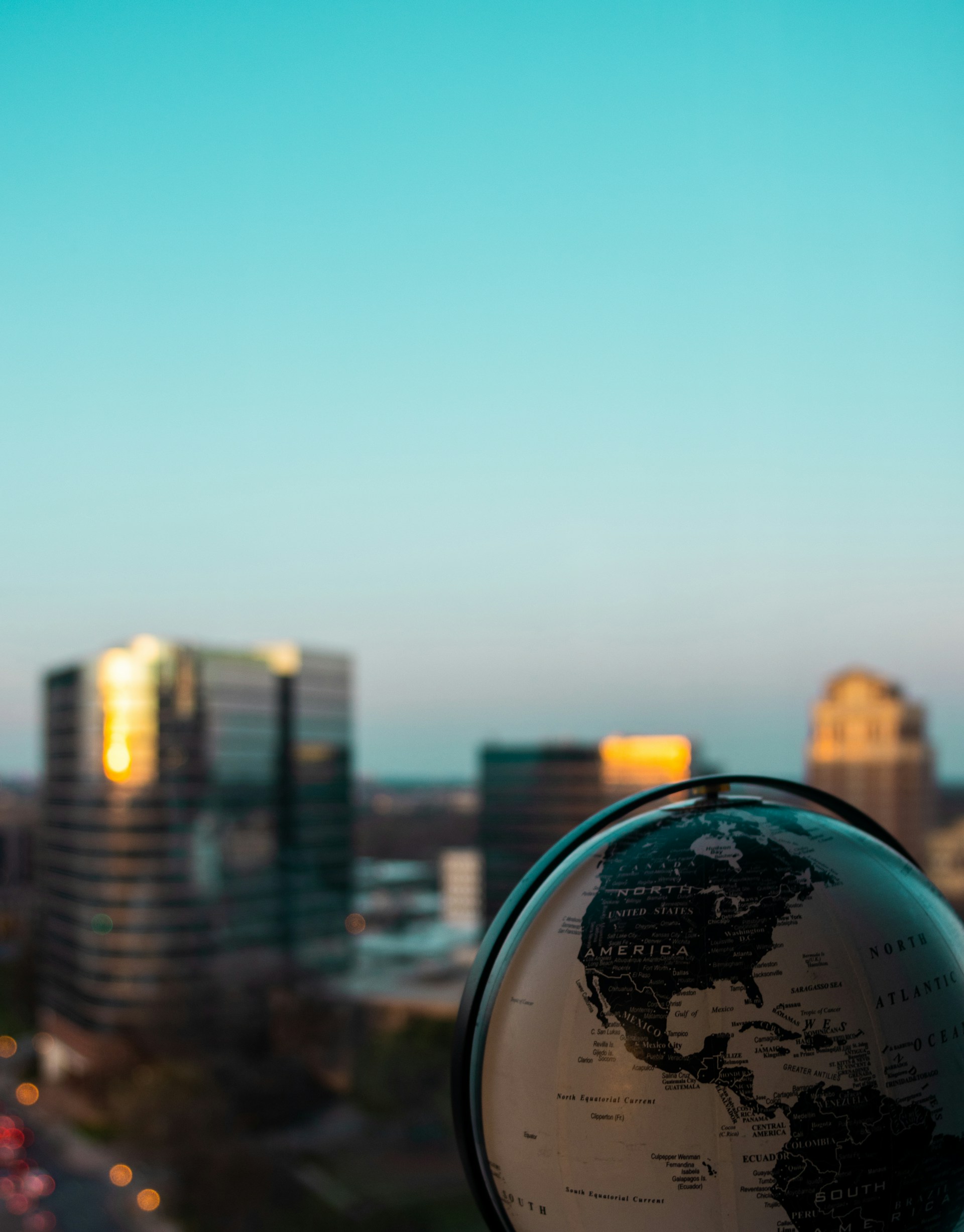 clear glass ball with city buildings in the distance