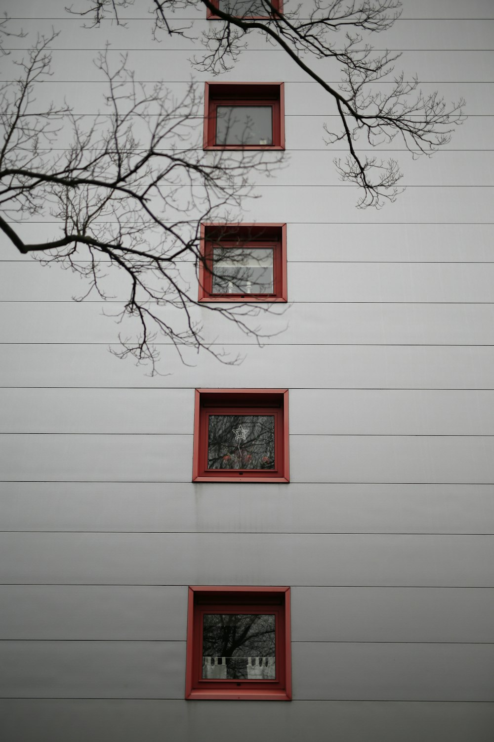 red wooden framed window on white wall