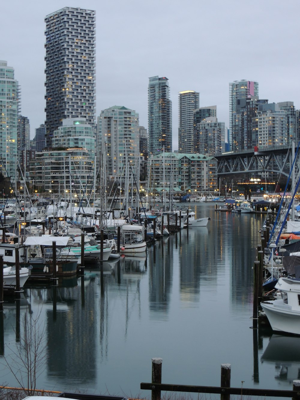 white and black boat on body of water near city buildings during daytime