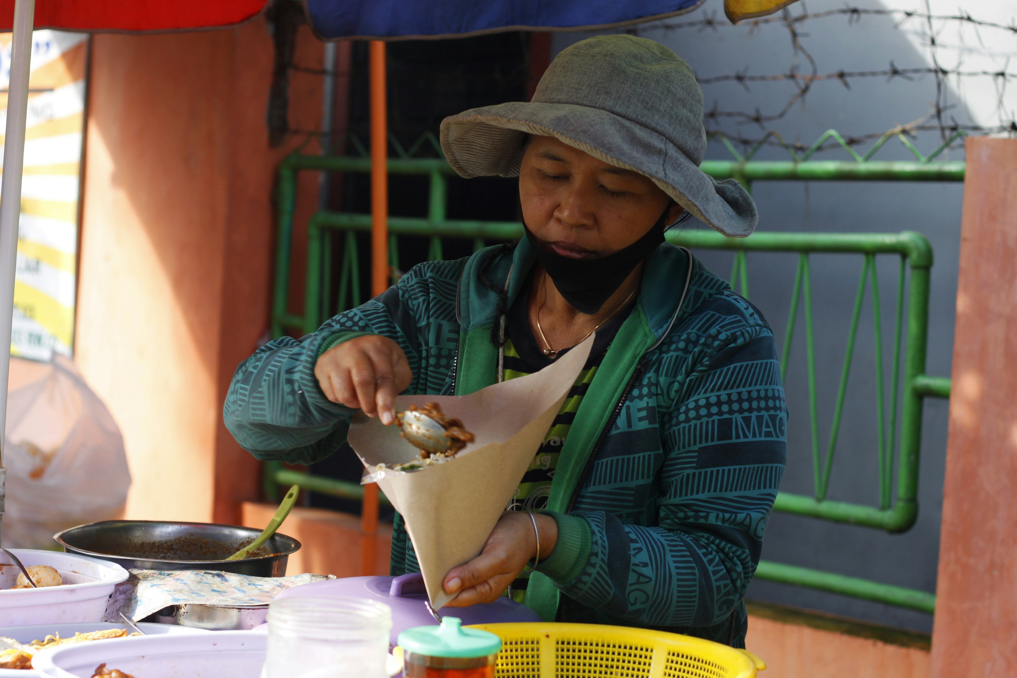 A woman is preparing breakfast for her customer