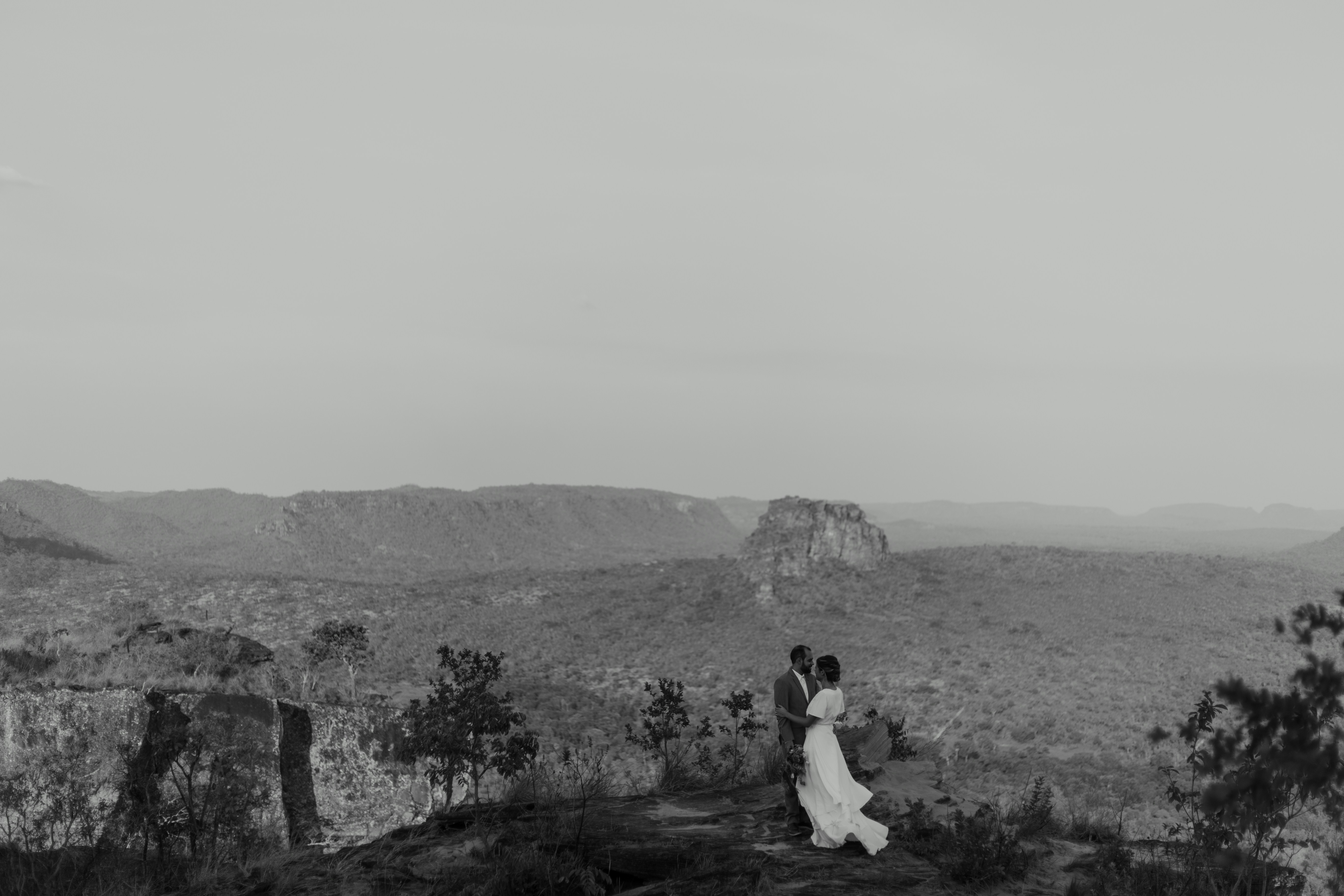 Dramatic documentary shot of a bride and groom sharing a quiet moment in a dimly lit room