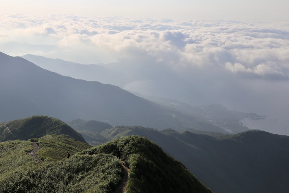 green mountains under white clouds during daytime