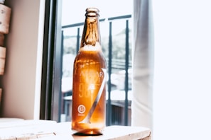 A clear plastic bottle filled with a colorful liquid on a wooden table.