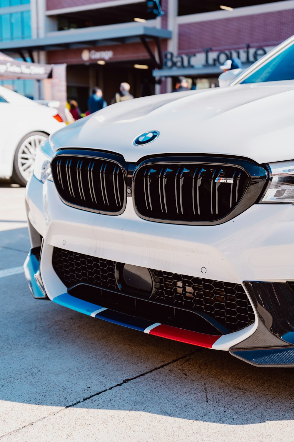 white bmw m 3 on road during daytime