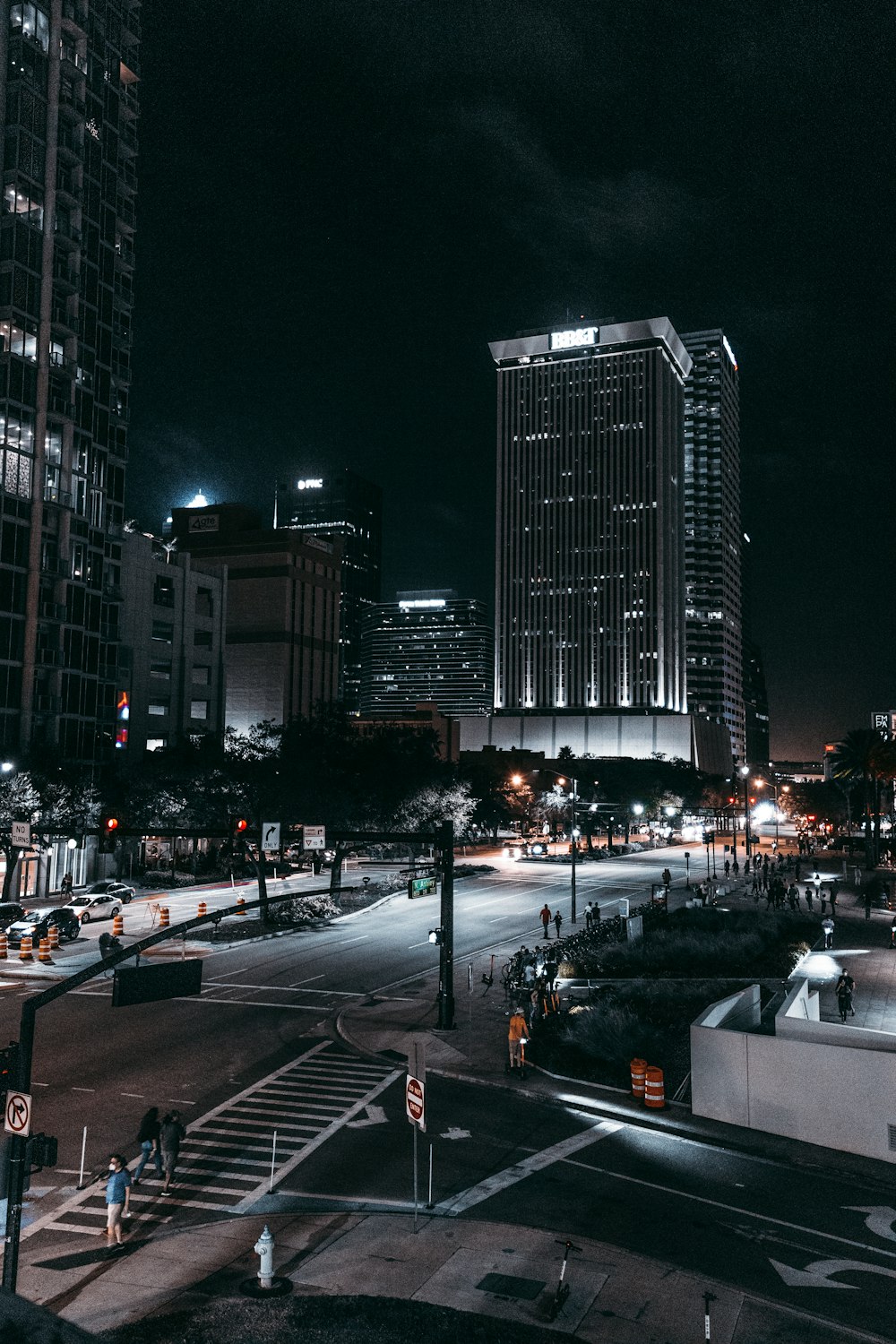 cars on road near high rise buildings during night time