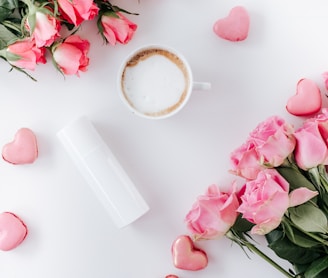 pink roses beside white ceramic mug