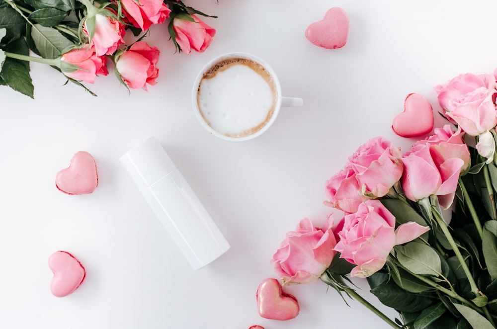 pink roses beside white ceramic mug