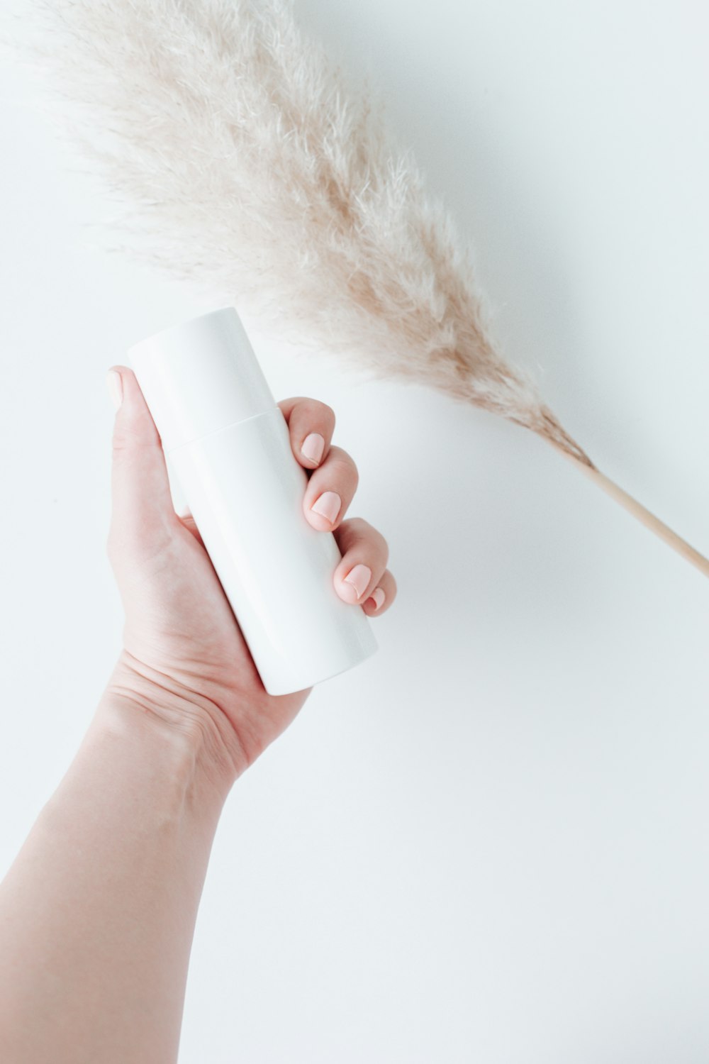 person holding white plastic bottle