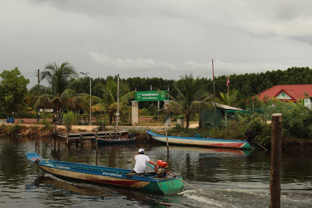 man in white shirt riding red kayak on river during daytime