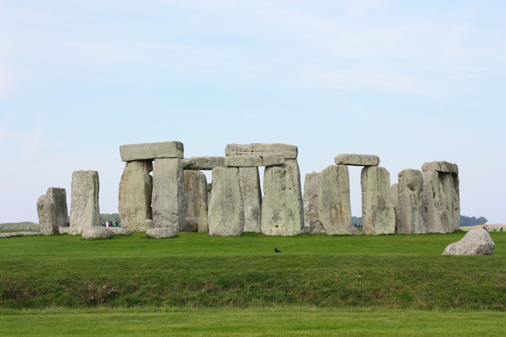 gray rock formation on green grass field during daytime