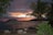 A serene beach setting with elegant lounge chairs and a sunset backdrop.