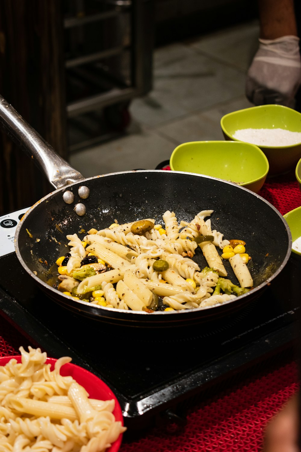 black frying pan with pasta