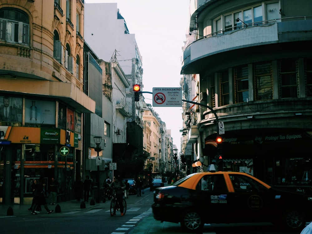 cars on road between buildings during daytime