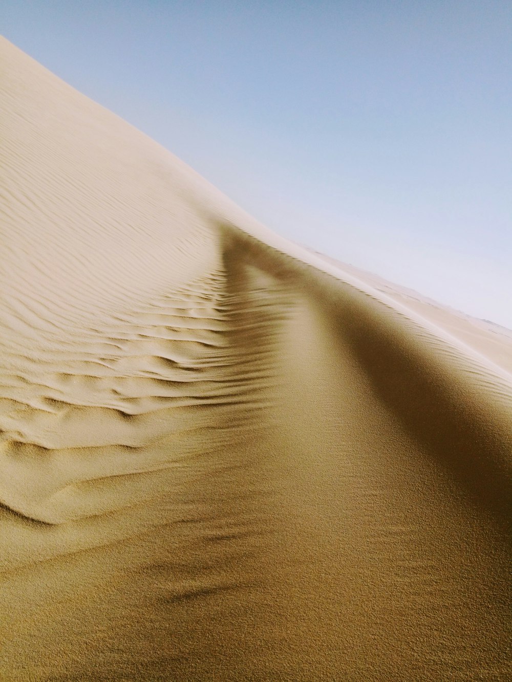 brown sand under blue sky during daytime