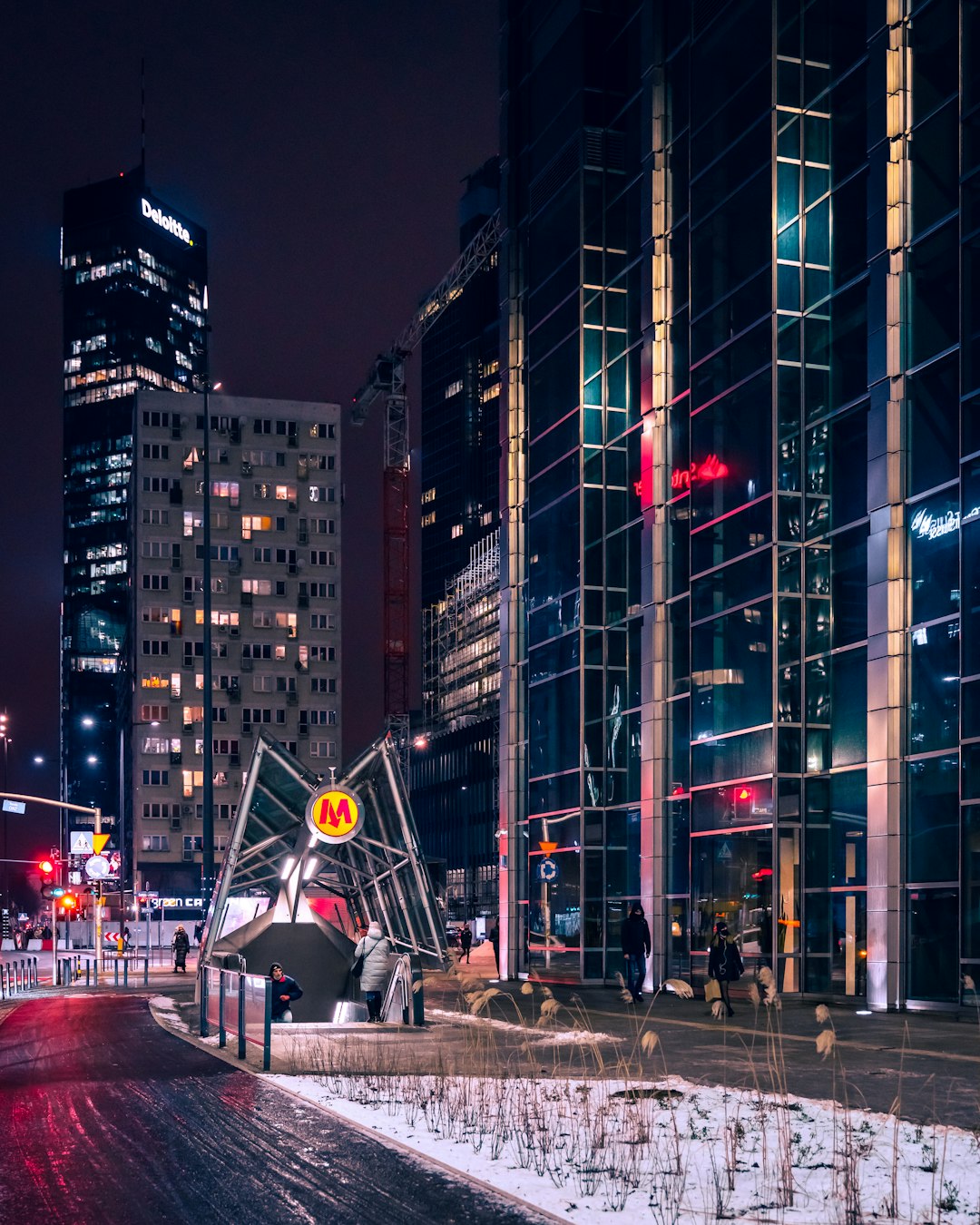 cars on road near high rise buildings during night time