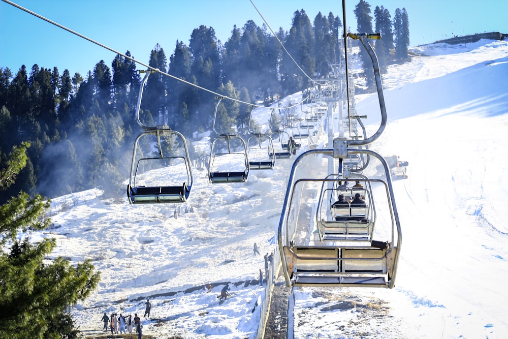 white cable car over snow covered ground during daytime