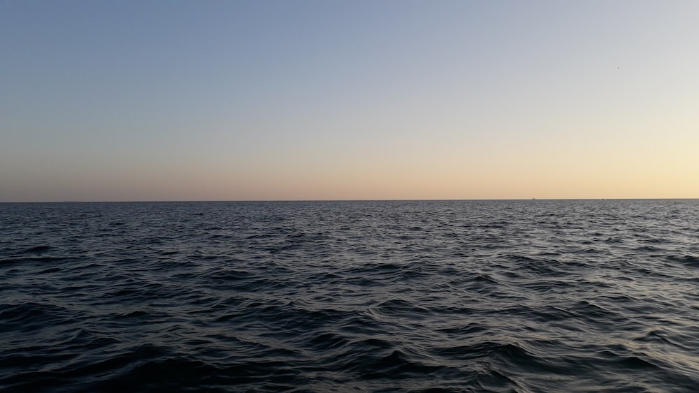 body of water under blue sky during daytime