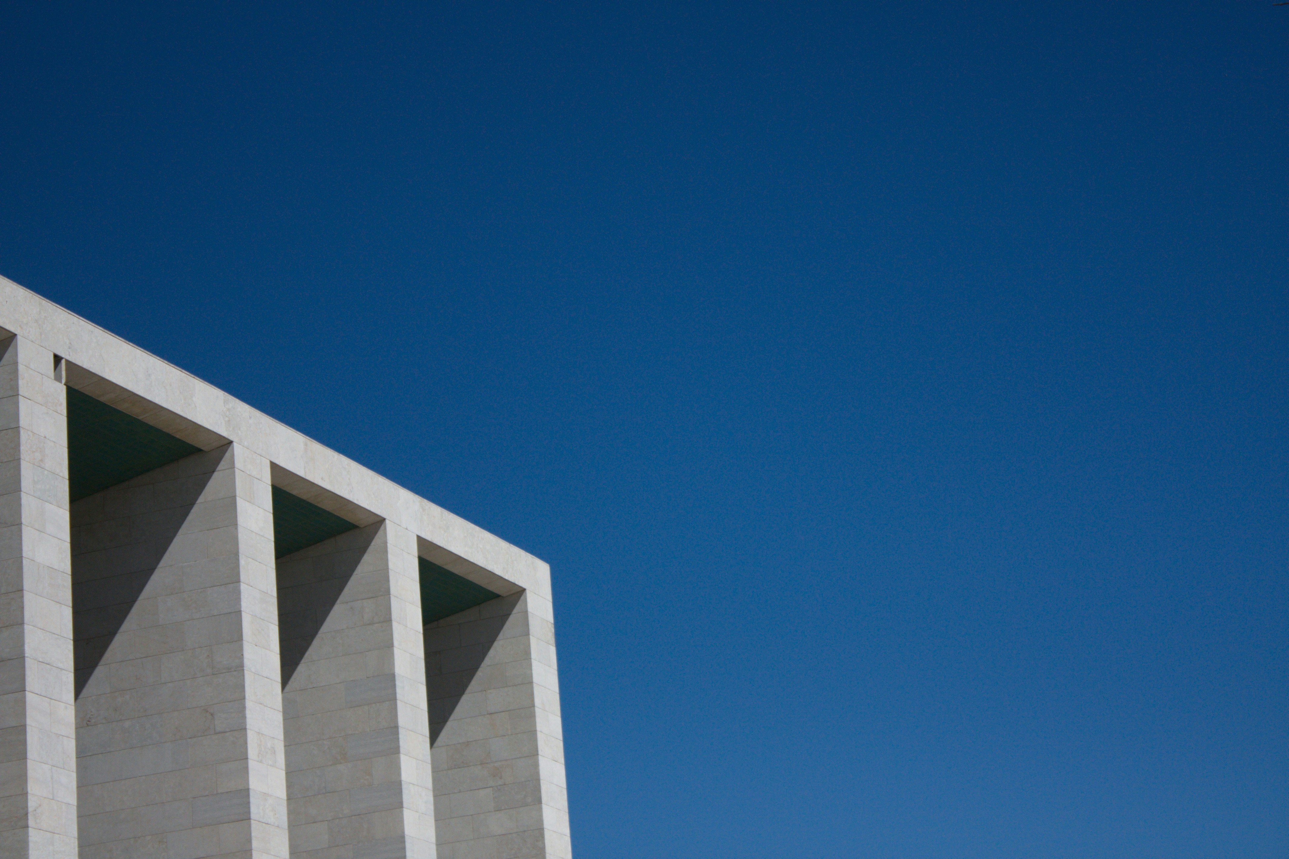 white concrete building under blue sky during daytime