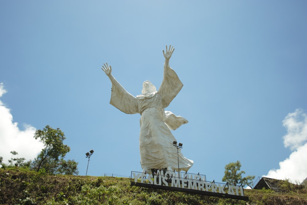 white statue of angel during daytime
