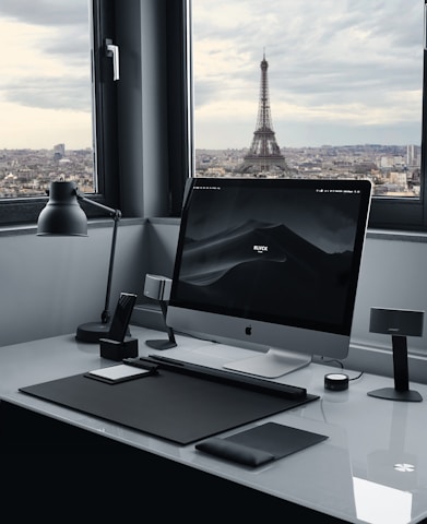 A sleek office workspace in Paris with developers collaborating over code on multiple screens.