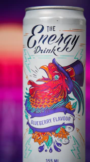 A vibrant energy drink can with the Long Jump logo, surrounded by splashes of bright colors.