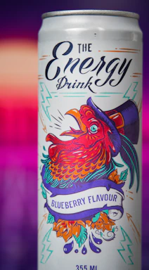 A vibrant energy drink can with the Long Jump logo, surrounded by splashes of bright colors.